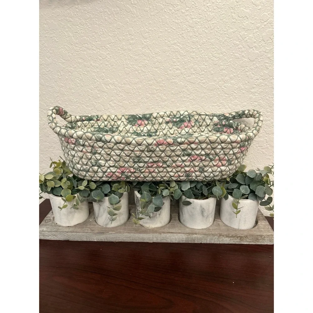 vintage oval rag rug basket features a braided, quilted design in green and pink